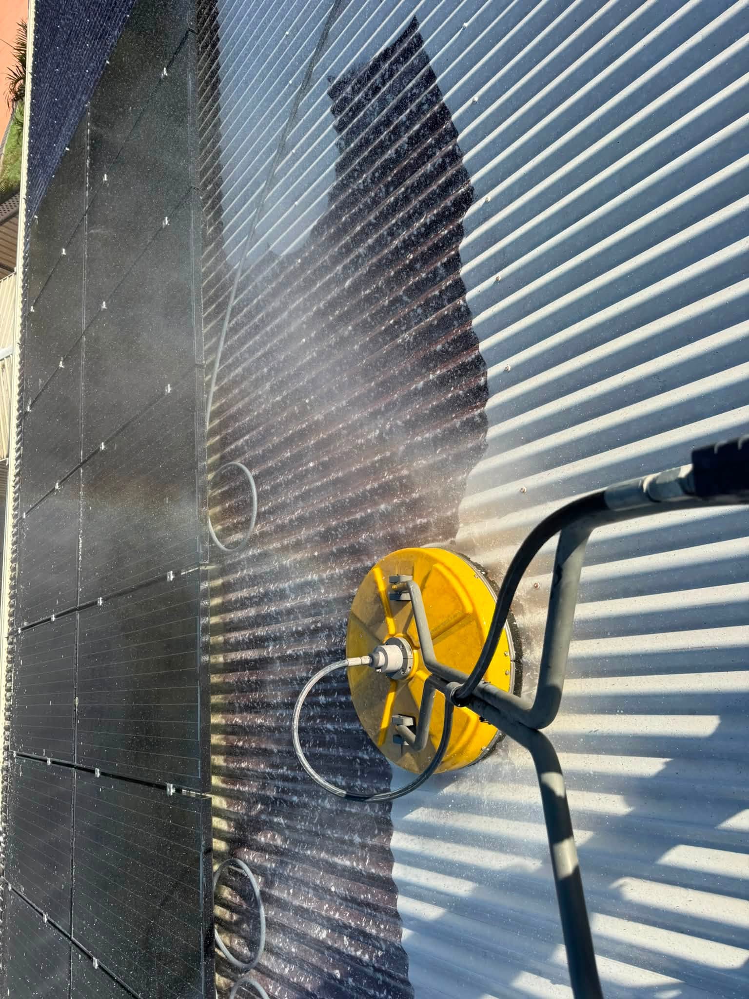 Solar panels half cleaned by Wilson Pressure Washing showing the difference